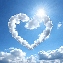 a heart shaped cloud in a blue sky with the sun shining through it