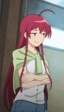 a girl with red hair and a green scarf around her neck is standing with her arms crossed