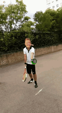 a man is holding a tennis racquet with a green sticker on his arm that says ' i love you '