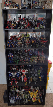 a collection of transformers toys on a shelf including one that says ' transformers ' on it