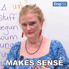 a woman stands in front of a whiteboard with the words " makes sense " on it