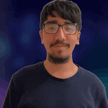 a man with glasses and a beard wears a black shirt