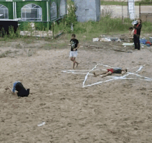 a man in a t-shirt that says ' i love you ' on it walks across a sandy field