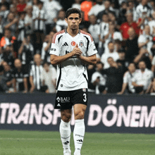 a soccer player with the number 3 on his shorts is standing on the field