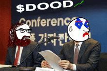 a man in a suit and tie is speaking into a microphone in front of a $ dood conference sign