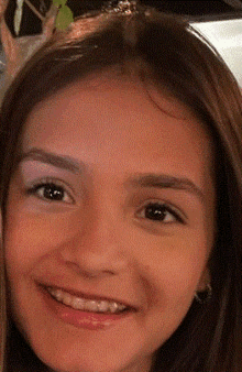 a close up of a girl 's face smiling