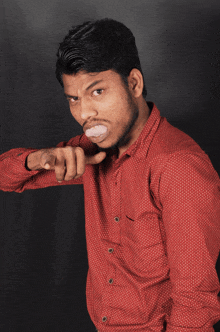 a man in a red shirt is pointing his finger