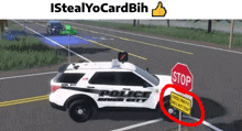 a police car driving down a road with a stop sign