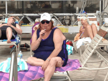 a woman in a bathing suit is smoking a cigarette