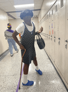 a person in a polka dot dress holding a cane and a purse