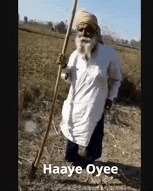 a man with a beard is holding a stick in a field with the words haaye oysee written on the bottom