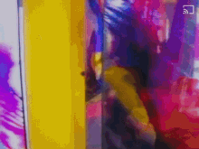 a blurry picture of a person standing in front of a yellow door