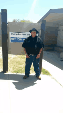 a man stands in front of a sign that says do n't pollute lakes and rivers