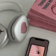 a pair of headphones sit next to a stack of things i like things