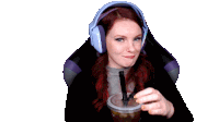 a woman wearing headphones and holding a cup with a straw