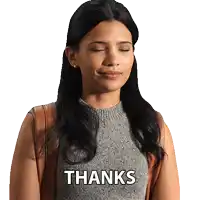 a woman with her eyes closed is wearing a sweater that says thanks on it