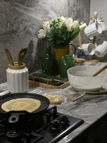 a pan with a pancake in it sits on a stove top