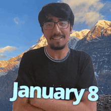 a man wearing glasses and a black shirt with the date january 8 on it