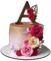 a pink and gold cake with flowers and a letter a on top