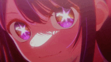 a close up of a girl 's eyes with a purple star in them