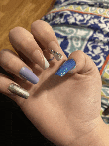 a close up of a person 's nails with a blue nail polish