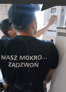 a man wearing a shirt that says masz mokro