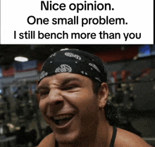 a man wearing a bandana is laughing in a gym