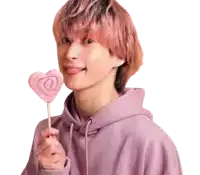 a young man with pink hair is holding a heart shaped lollipop