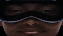 a close up of a person 's face with a pair of goggles on