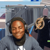 a man wearing headphones is smiling in front of a sign that says ' donate through super chat '