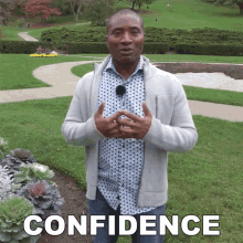 a man in a polka dot shirt stands in front of a park with the word confidence written on the bottom