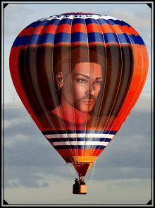 a colorful hot air balloon with a picture of a man on it