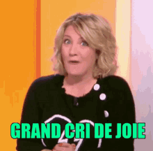 a woman with a surprised look on her face and the words grand cri de joie in green letters .