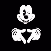 mickey mouse is making a heart shape with his hands and winks .