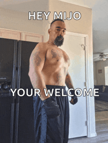 a shirtless man stands in front of a black refrigerator with the words hey mijo your welcome written on the bottom