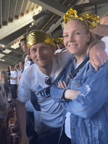 a man wearing a white adidas shirt is standing next to a woman