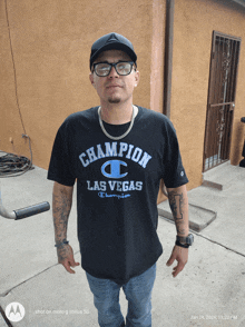 a man wearing a champion las vegas shirt