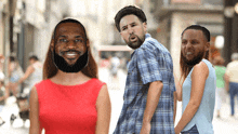 a man with a beard is standing next to two women