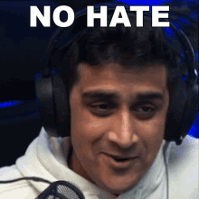 a man wearing headphones with the words no hate written above him