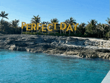 a sign that says perfect day on a beach