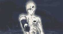 a man with a skull on his chest and arm is standing in the dark .