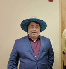 a man wearing a blue suit and a hat