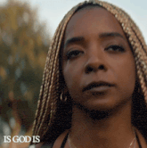 a close up of a woman 's face with the words " is god is " above her