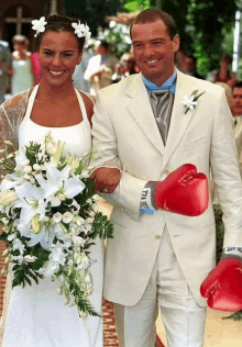 a bride and groom are walking down the aisle with boxing gloves that say everlast