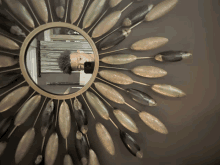 a man is taking a picture of himself in a sunburst mirror