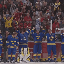 a group of hockey players are standing on the ice and one of their jerseys has the letter a on it