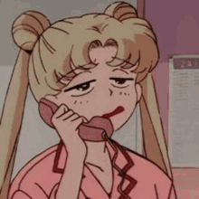 sailor moon is talking on a pink telephone .