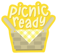 a yellow sign that says picnic ready with a basket in the background