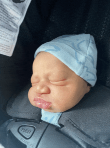 a baby is sleeping in a car seat with a label that says push