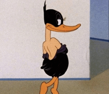 a cartoon duck wearing a black mask is standing in front of a white wall